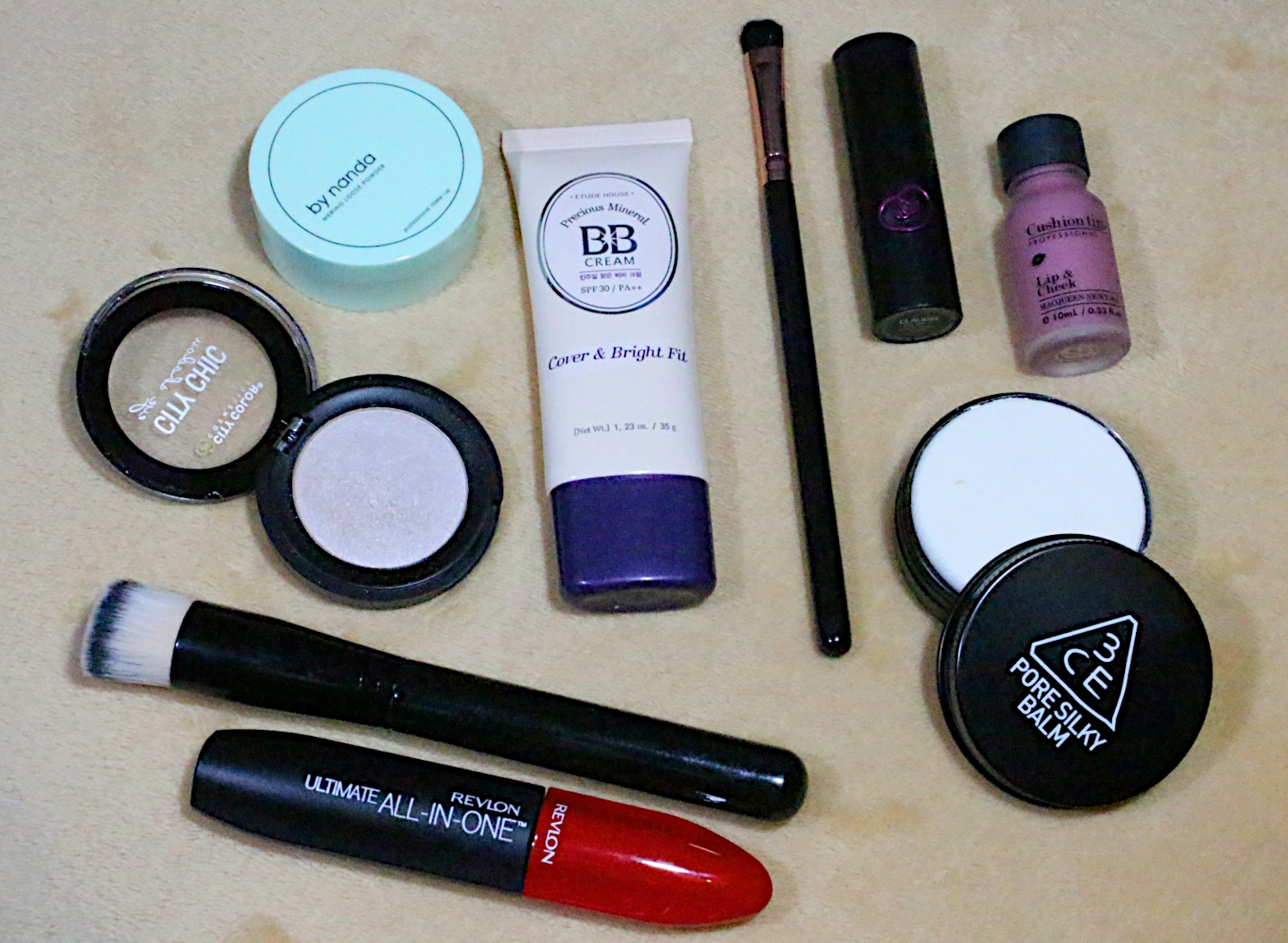 a flatlay of various makeup and beauty products