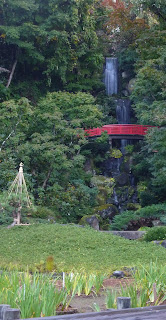 View of red bridge and waterfall at Fujita Memorial Gardens