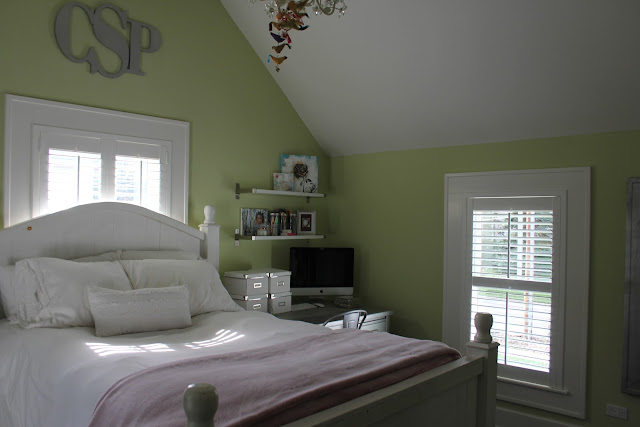 Modern farmhouse bedroom with green walls and plantation shutters on Hello Lovely Studio