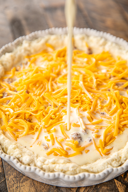 Sausage Biscuit Quiche - our FAVORITE quiche! The crust is made out of homemade biscuit dough. It is like a big open faced sausage, egg and cheese biscuit. SO good!!! Self-Rising flour, butter, buttermilk, sausage, cheese, eggs, half-and-half and sour cream. Great for breakfast, lunch or dinner. Everyone LOVES this yummy casserole!!! #quiche #breakfast #biscuit Sausage Biscuit Quiche - our FAVORITE quiche! The crust is made out of homemade biscuit dough. It is like a big open faced sausage, egg and cheese biscuit. SO good!!! Self-Rising flour, butter, buttermilk, sausage, cheese, eggs, half-and-half and sour cream. Great for breakfast, lunch or dinner. Everyone LOVES this yummy casserole!!! #quiche #breakfast #biscuit