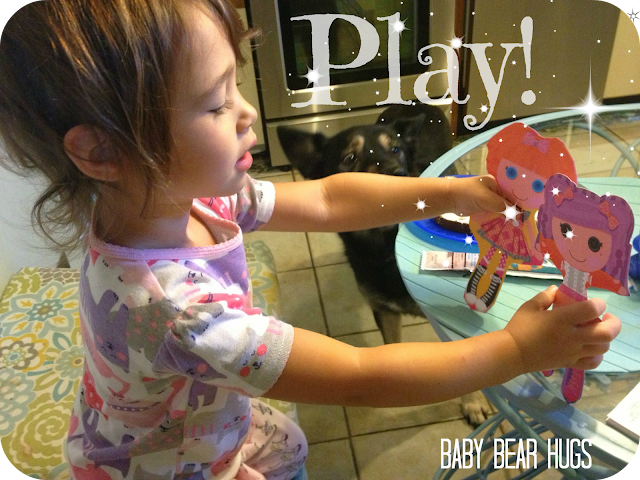 little girl playing with paper dolls