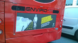 Advert on back of London bus warning cyclist to ride at least 1m from parked cars to avoid being doored.