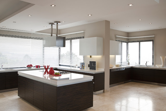 Picture of large modern kitchen with brown wooden furniture and marble surfaces