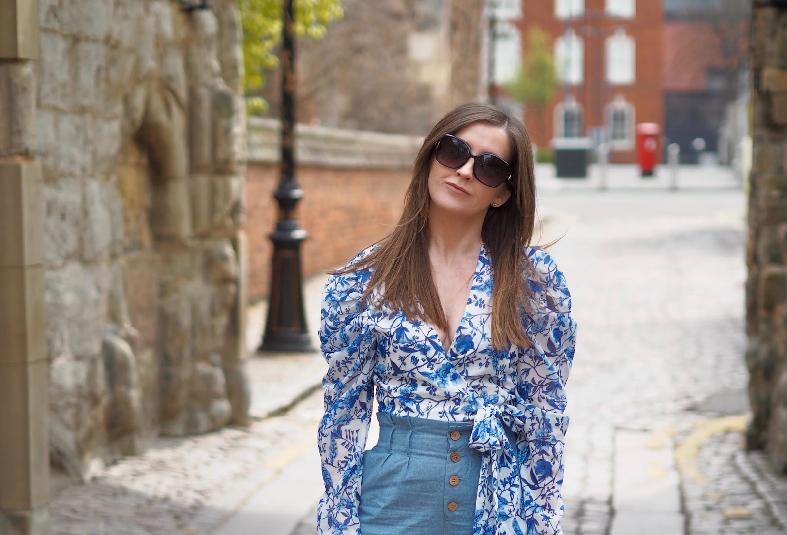 Practically perfect wrap top by Lorna Luxe styled with high waisted trousers and sandals 