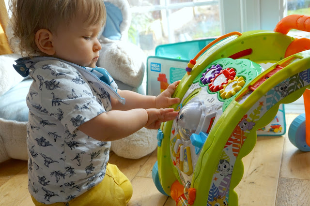 toddler playing with the little tikes light 'n' go walker