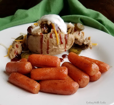 Carrots glazed with a bit of honey and cinnamon are a great side dish. A little sweet and a little salty, they make the perfect vegetable for Easter, Thanksgiving, or any dinner! glazed carrots on a plate with pulled pork stuffed baked potato