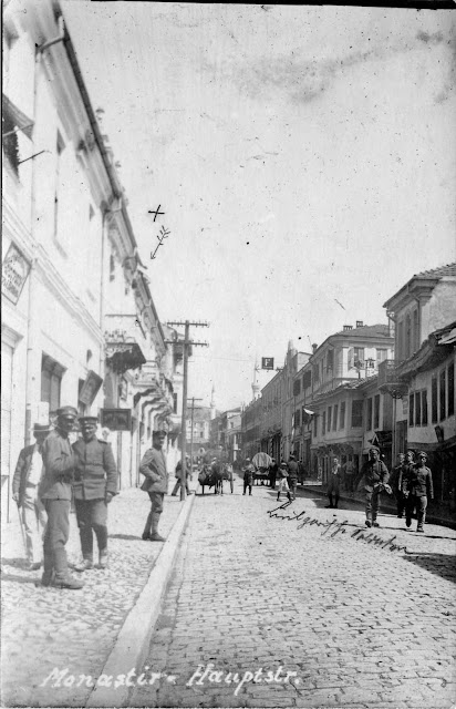 The main street (Sirok Sokak) in front of hotel "Bosna" in 1916. German soldiers standing and posing for this photograph. In the background are seen Isak and Yeni Mosque. Telephone poles on left side of this photograph confirm that phones in the city were in use. Old houses on the right side of this image were ruined by bombing in 1917.