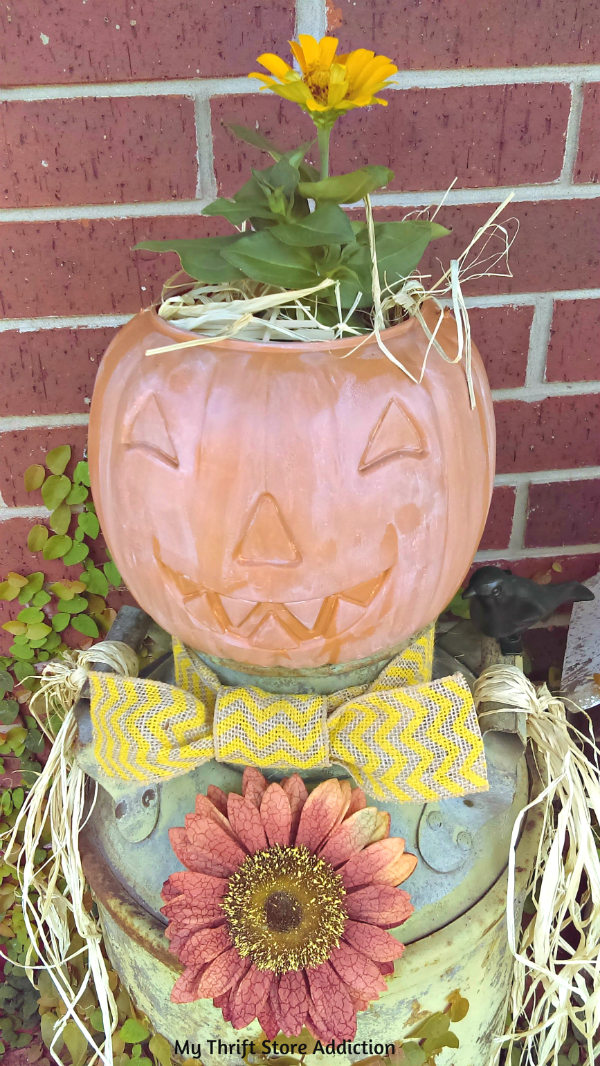 Repurpose a vintage milk can and a plastic pumpkin as a whimsical scarecrow for your garden or porch! repurposed vintage milk can scarecrow