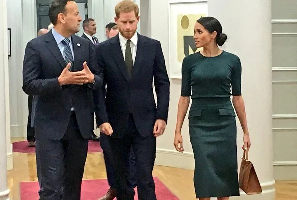 Meghan Markle wore Givenchy patch pocket pencil skirt, and Vanessa Tugendhaft Charm earrings, carried Strathberry handbag