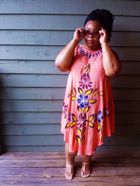 Plus size blogger in dress, sandals, sunglasses, faux locs and gazing into sunset