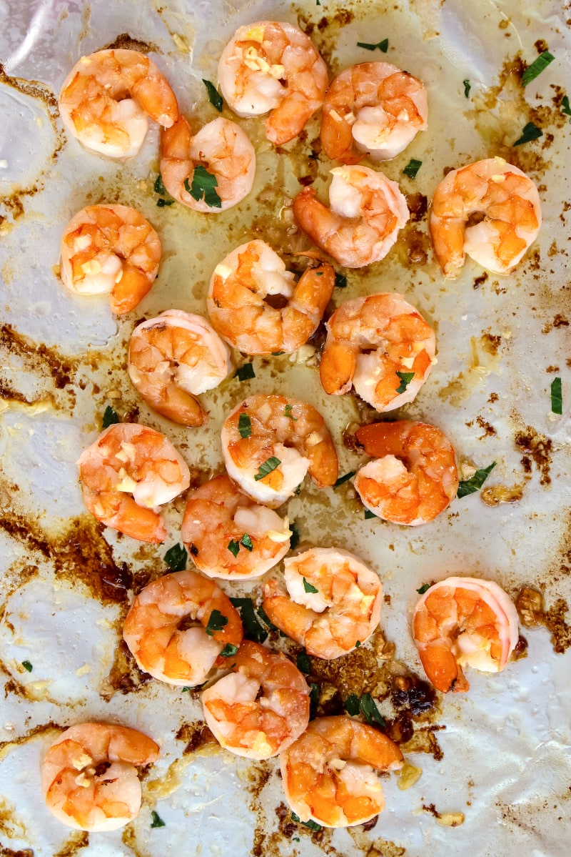 10 Minute Garlic Butter Baked Shrimp is an easy recipe for perfectly cooked, garlicky, buttery shrimp that is baked on a sheet pan in just 10 minutes! #shrimp #sheetpan #seafood