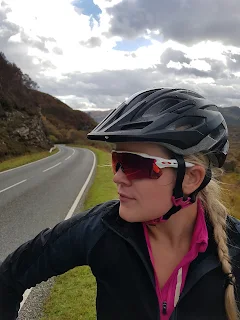 girl in road biking gear with white sunglasses