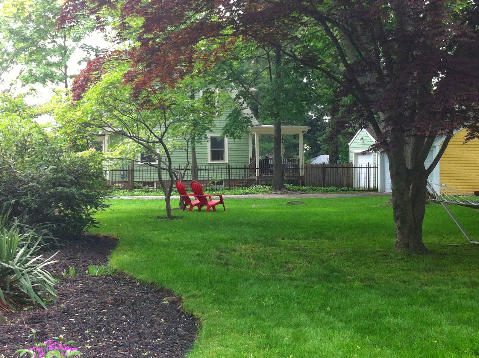 Red adirondack chairs in Providence yard