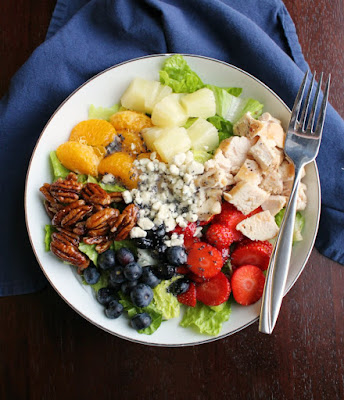 The best part of a salad is always the toppings and this beauty is loaded with the good stuff. All of the fruit, chicken, nuts and cheese go deliciously with the simple to make poppy seed dressing. You will find yourself serving salad a lot more frequently after you try this Portillos inspired chicken and fruit poppy seed salad! Portillos copycat fruit and chicken salad drizzled with homemade poppy seed dressing