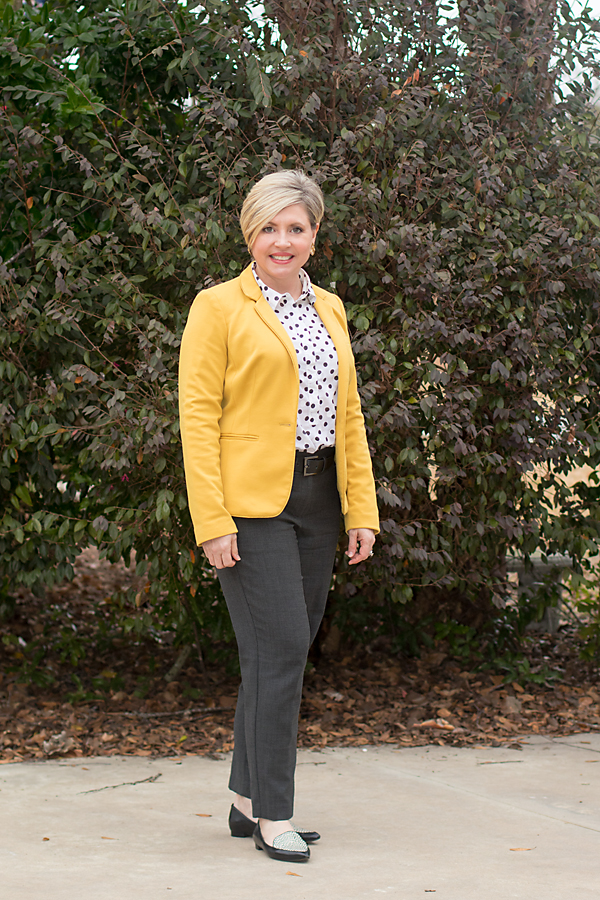 mustard blazer with black and white polka dot top and grey ankle pants