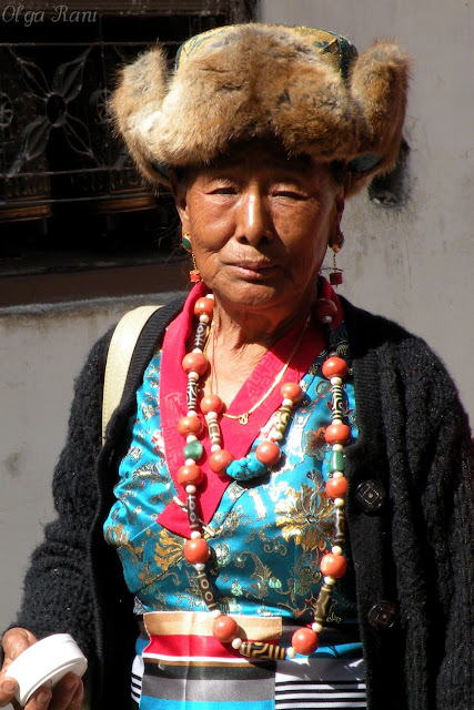 Tibetan woman wearing dzi beads, coral and turquoise necklaces