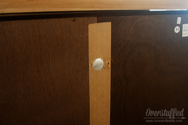 Hole in back of unit. You will also need to drill a hole in the back of the unit for the plugs to fit through.