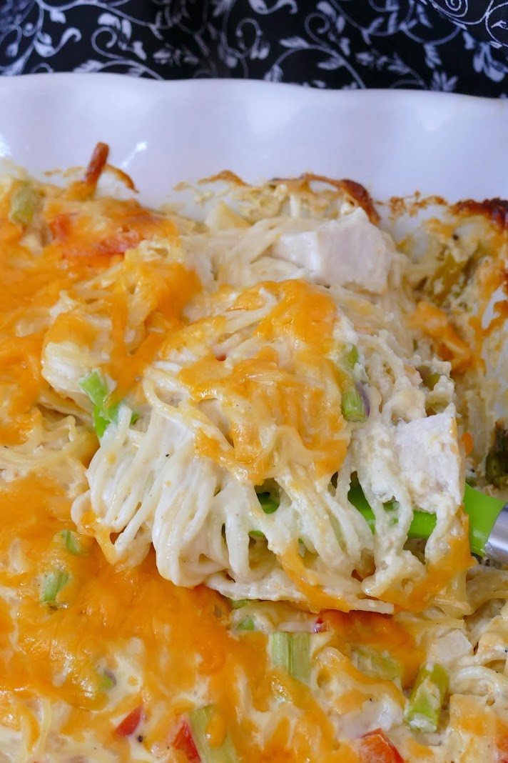 Cheesy Chicken and Asparagus Spaghetti Casserole Recipe! This creamy angel hair pasta bake is a great way to use leftover rotisserie chicken! It's budget friendly and the whole family will love it! 