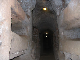 Grave niches were carved out of the rock in the  passageways of the Roman catacombs