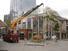 small crane lifting a fallen tree at the Midtown in Zhuhai