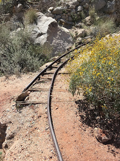 Rails leave the main entrance to the Betty Lee Mine Narrow gauge rails lead from mine to tailing pile