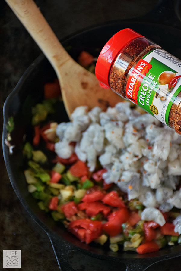 Adding chopped shrimp and creole seasoning to the sauteed vegetables for Skillet Jambalaya dip