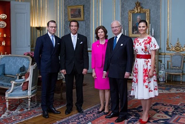 Crown Princess Victoria in a red and white flower dress meeting with the President of Botwana Ian Khama at the Royal Palace