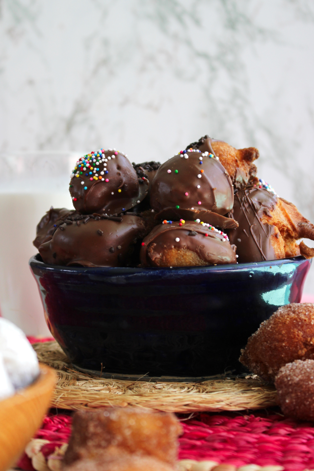 Homemade Drop Doughnuts are the perfect sweet treat for a weekend morning, made with a quick, one-bowl batter that is fried until puffed and golden brown.  Dress your doughnuts up with your favorite toppings like cinnamon sugar, powdered sugar, and chocolate!