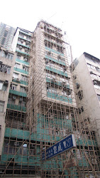 Building covered in bamboo scaffolding.