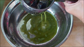 squeezing juice from minced pandan leaves