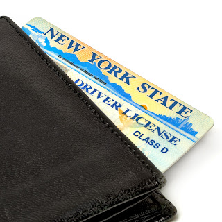 A photo of a New York State driver license and a wallet A photo of a New York State driver license and a wallet