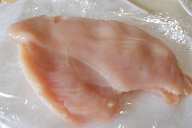 Pound the chicken breasts for chicken Parmesan between double pieces of plastic wrap. Pounded chicken breasts for chicken Parmesan