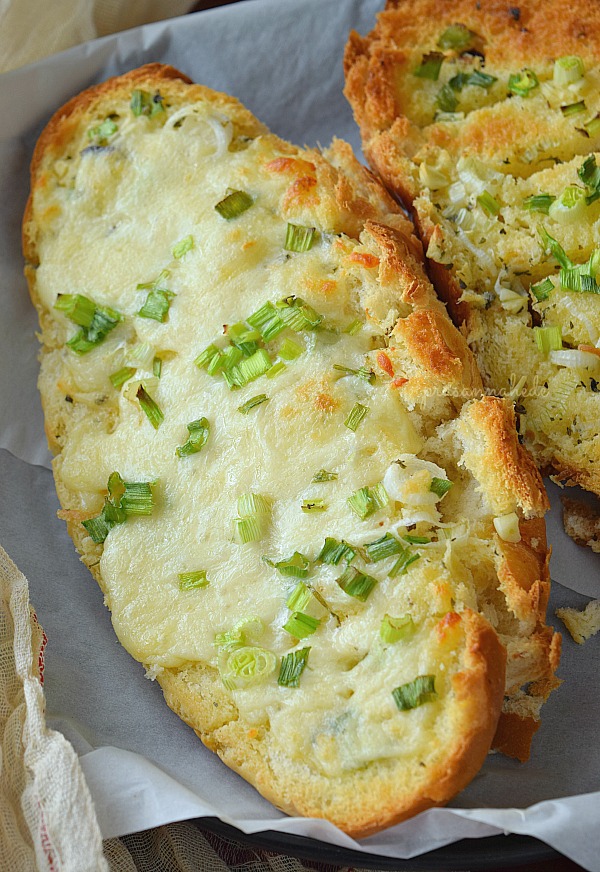 Appetizer Cheese Garlic Bread served on white surface
