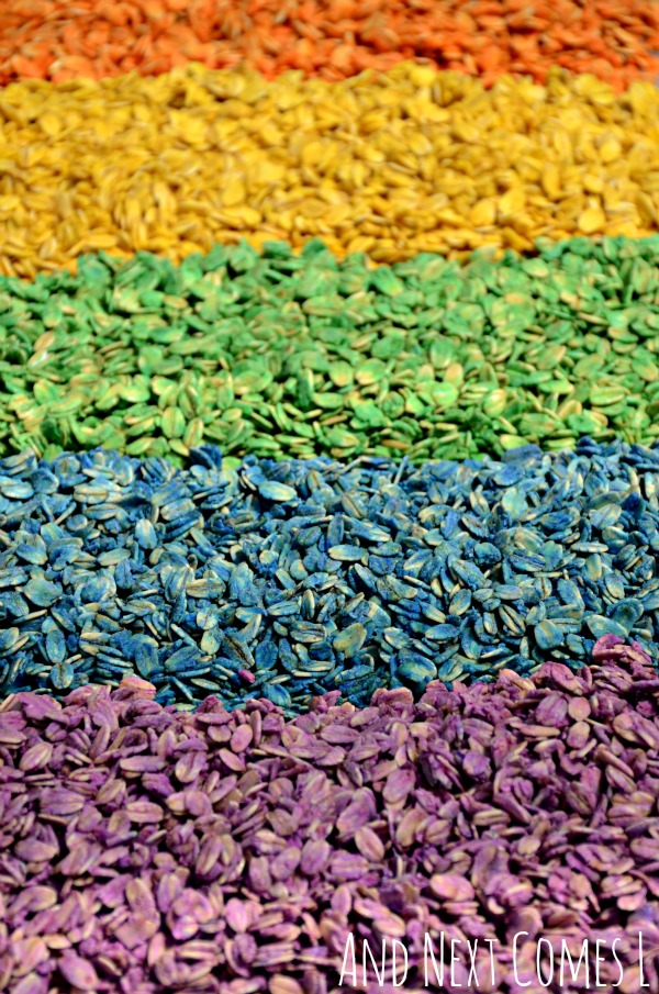 Colored oatmeal sensory bin for kids