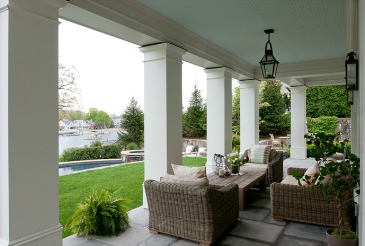 Coastal outdoor space with harbor view Coastal outdoor space with wicker seating and a view of the harbor