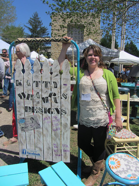 Kristin of Kattywhampus Designs posing in front of her booth
