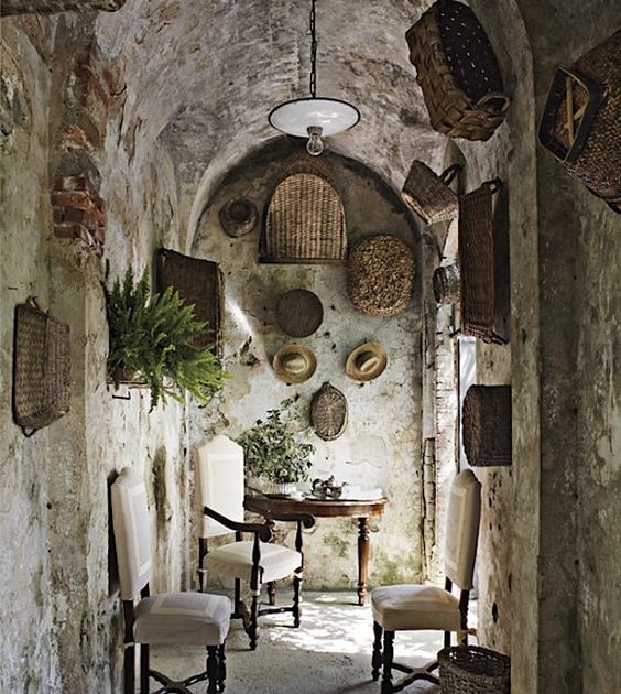 An unforgettable French farmhouse interior with stone walls covered in baskets. #frenchcountry #frenchfarmhouse #stone #frenchbasket