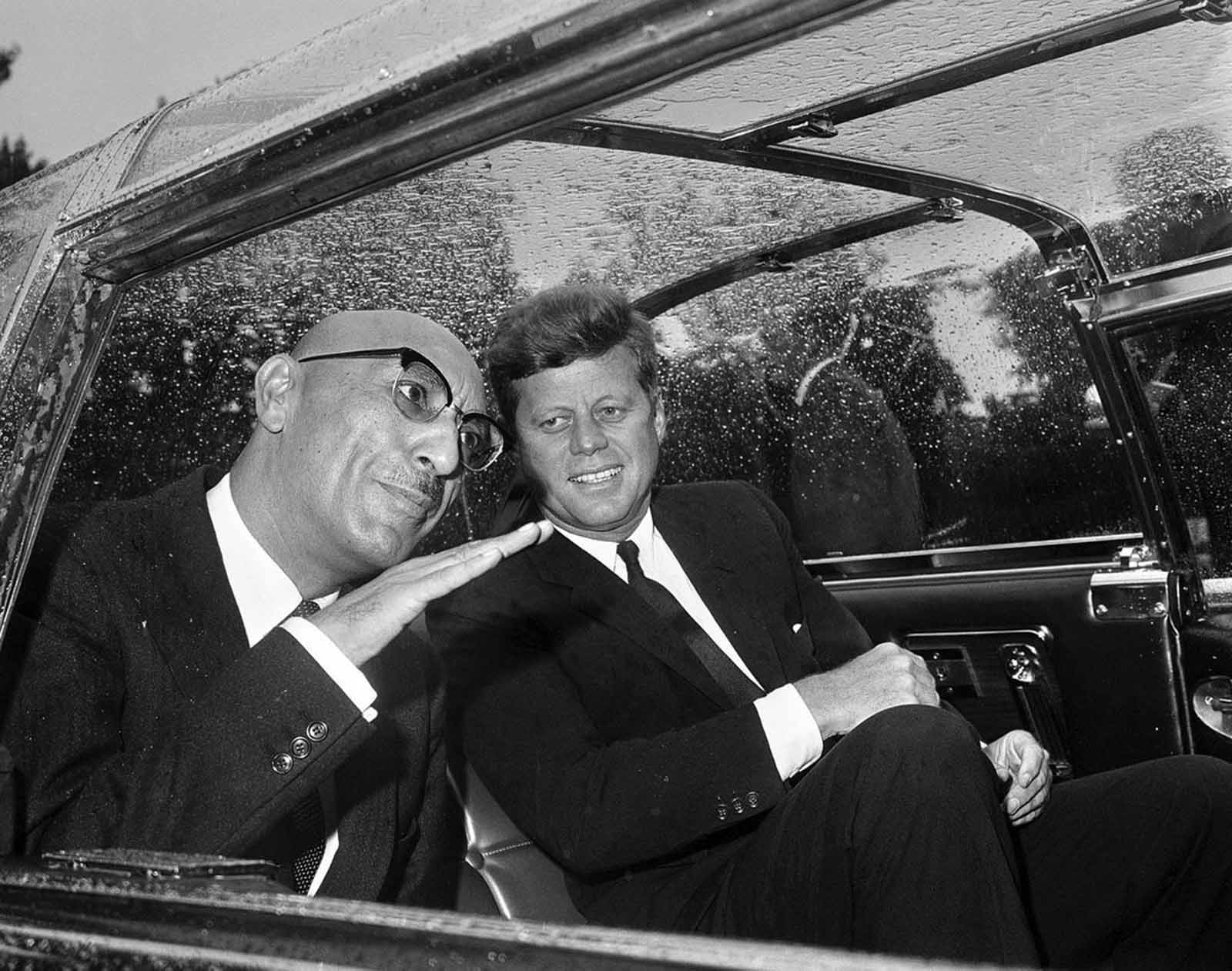 In Washington, District of Columbia, Afghan King Mohammad Zahir Shah talks with US President John F. Kennedy in the car that took them to the White House on September 8, 1963.