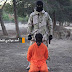 ISIS hanging man by feet & shooting him with gun