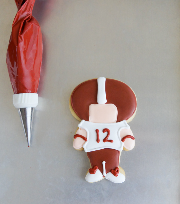 step-by-step tutorial for making football player cookies