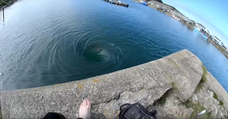 Photographer jumps into an ocean whirlpool