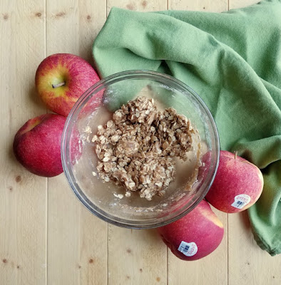 The perfect individual sized dessert, these mini apple crisp baked apples are the perfect mix of baked apples and crisp topping. Serve it with a scoop of ice cream for a perfect dessert! bowl of crisp topping with whole apples around it