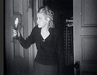 Marjorie (Barbara Pepper) looks around the dark, creepy tavern