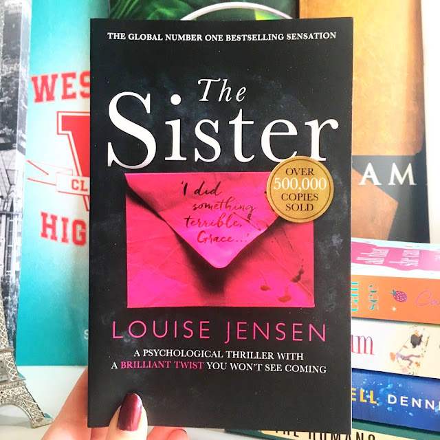 The Sister by Louise Jensen held up in front of musical programs