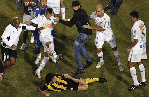 Santos and Peñarol players fight after their Copa Libertadores final match