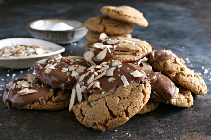 Almond butter cookies coated with chocolate and sprinkled with slivered almonds and sea salt.