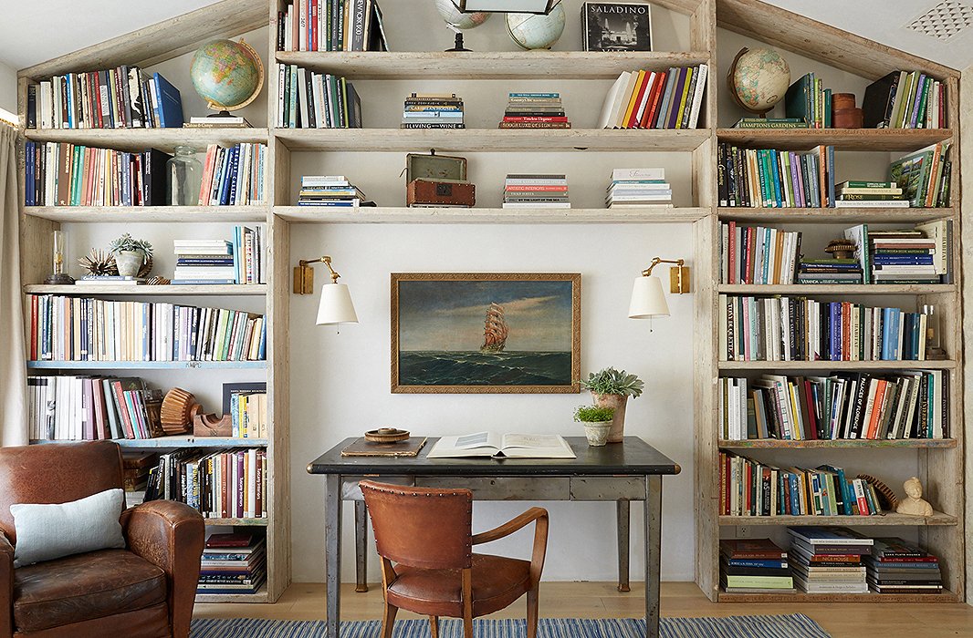 Modern farmhouse den office with wood bookshelves and leather club chairs at Patina Farm