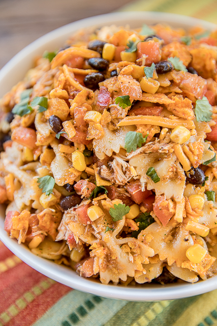 Chicken Fajita Bow Tie Pasta Salad - crazy good!! Chicken and bow tie pasta tossed with lime juice, cumin, chili powder, cilantro, olive oil, corn, tomatoes, black beans, salsa, cheese and Doritos! Can make without the chicken and serve as a side dish. Great for summer potlucks! #pastasalad #mexican #chickenrecipe #easyrecipe #nobakerecipe Chicken Fajita Bow Tie Pasta Salad - crazy good!! Chicken and bow tie pasta tossed with lime juice, cumin, chili powder, cilantro, olive oil, corn, tomatoes, black beans, salsa, cheese and Doritos! Can make without the chicken and serve as a side dish. Great for summer potlucks! #pastasalad #mexican #chickenrecipe #easyrecipe #nobakerecipe