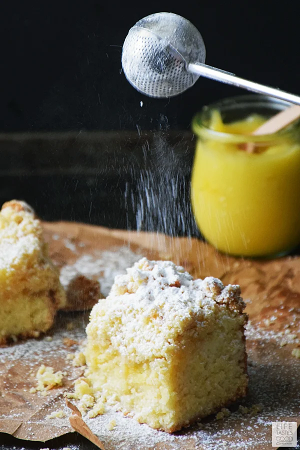 Dusting powdered sugar onto Lemon Crumb Cake