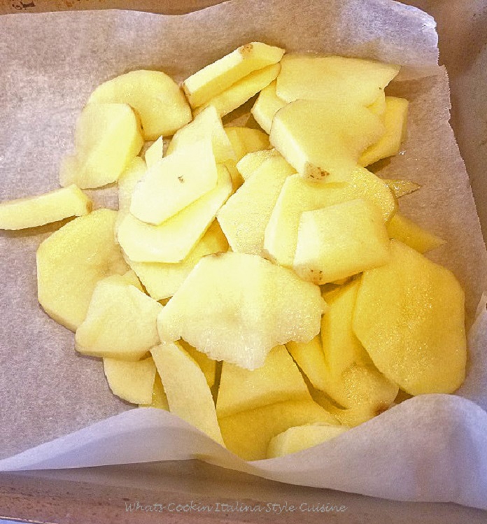 these are thinly sliced yukon gold potatoes on parchment lined 13 x 9 pan